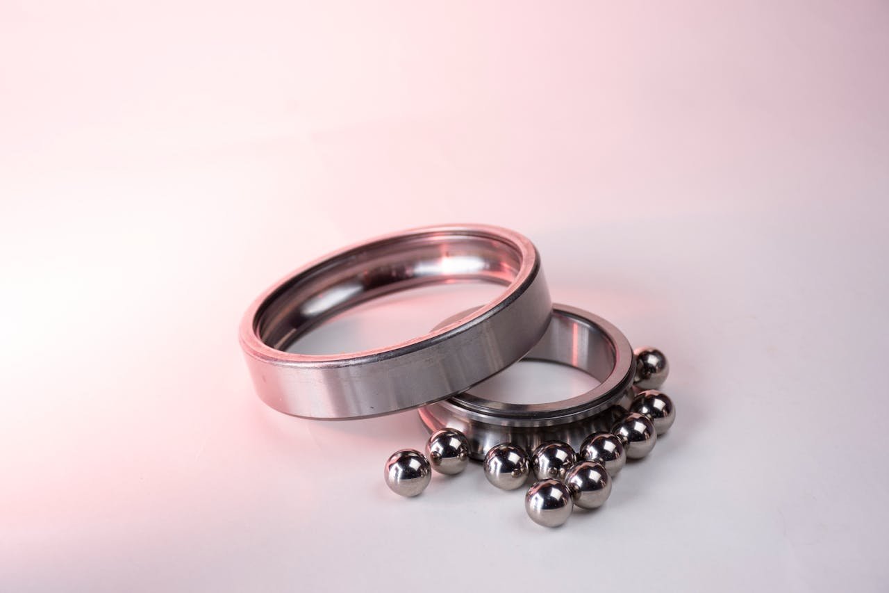 Detailed image of shiny metal bearings and rings on a white background.